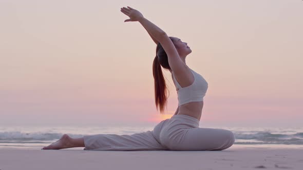 Young woman practicing yoga at the beach front for healthy mind and perfect body