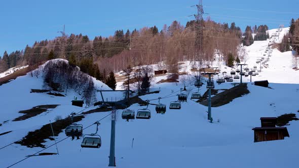 Ski Lift Moving Over Snowy Landscape in Austrian Alps