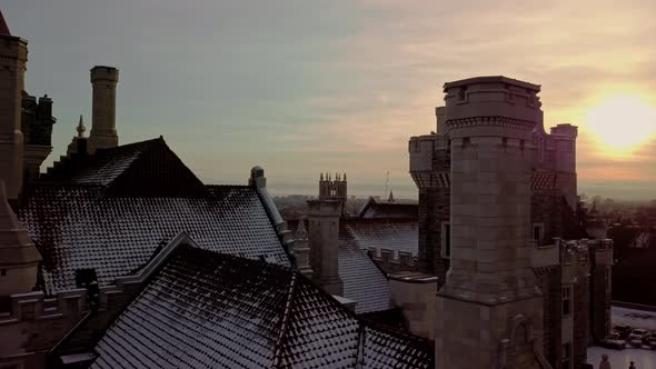 Towers and Tile Roof of a Scenic Castle at Sunset, Drone Slide Right. Aerial parallax truck of Casa