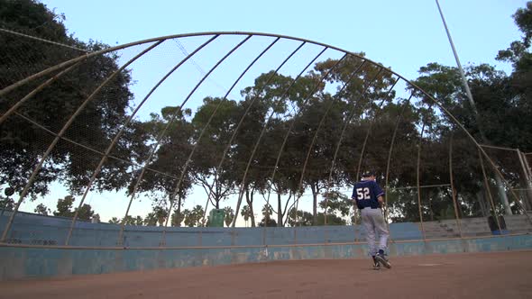 A baseball player practicing his swing.