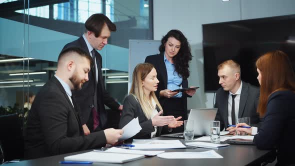 Business Team Working Together at Meeting Discussing Company Finances