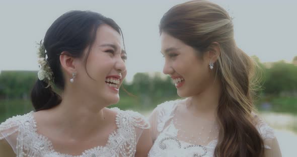 Happy Asian Lesbian Married Couple Enjoying Romantic Moments Outside, Slow Motion.