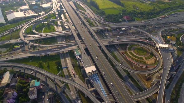 Aerial View of Highway Road Interchange with Busy Urban Traffic Speeding on Road