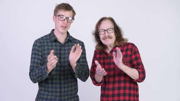 Happy Senior Hipster Man and Young Hipster Man Clapping Hands Together