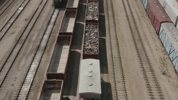 Scrap Metal Cargo Train Wagon on the RailRoad Tracks