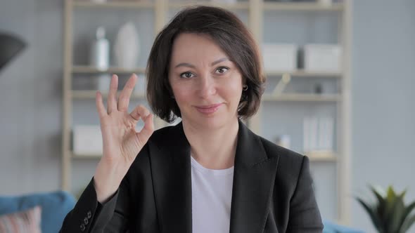 Portrait of Old Businesswoman Gesturing  Victory Sign