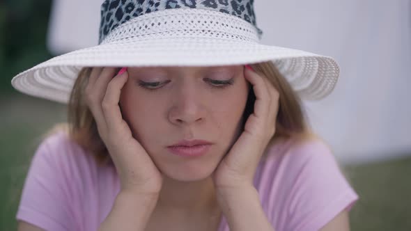 Closeup Face of Sad Young Beautiful Woman with Grey Eyes Looking at Camera Shaking Head