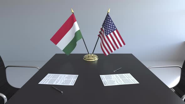 Flags of Hungary and the United States and Papers on the Table