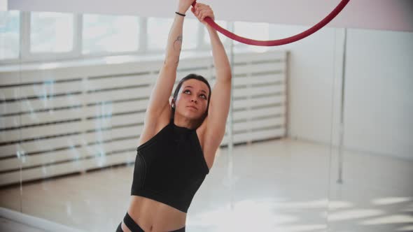 Gymnastic Training  Young Woman Holding By Acrobatic Ring and Climbs Up on It