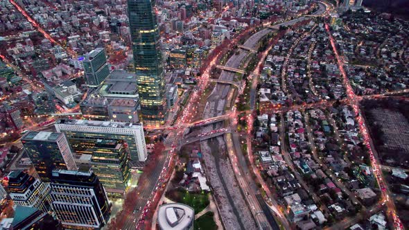 Aerial orbit of the Mapocho river and the bridges of Santiago, Chile. Traffic on the streets during