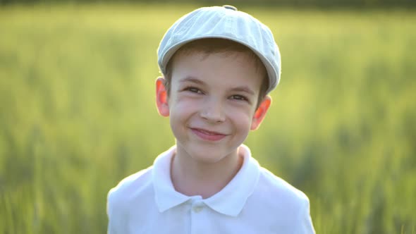 Portrait of Boy Standing in Fresh Green Wheat Field