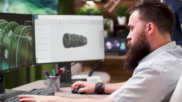 Bearded Hipster Architect Works on 3D Model of a Turbine