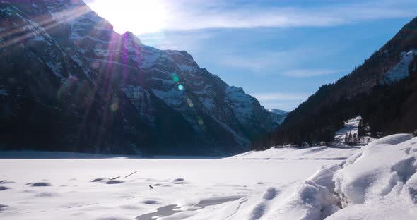Wonderful time lapse or hyper lapse shot of a valley in Switzerland with a frozen lake while the sun
