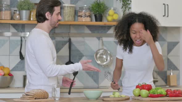 Mixed Race Couple Dancing in Kitchen