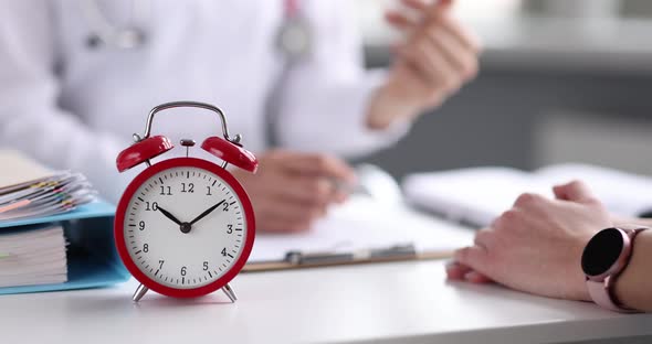 Group of Business People at Meeting in Office Table Alarm Clock Closeup