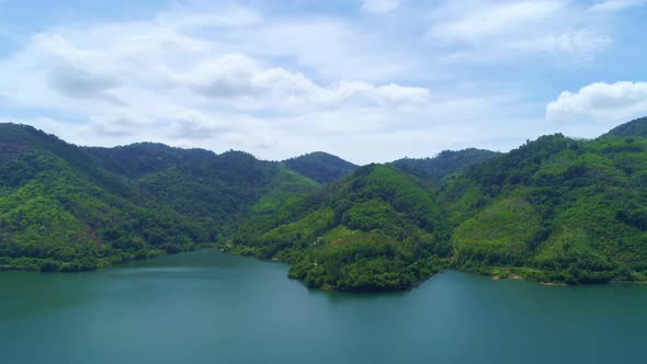 Tropical landscape rainforest with clouds flowing over mountain