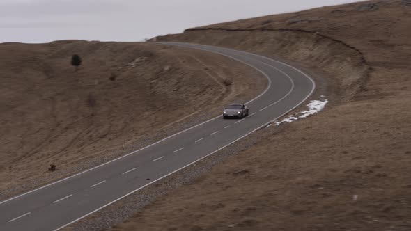 Car in the Mountains of the Caucasus in Winter