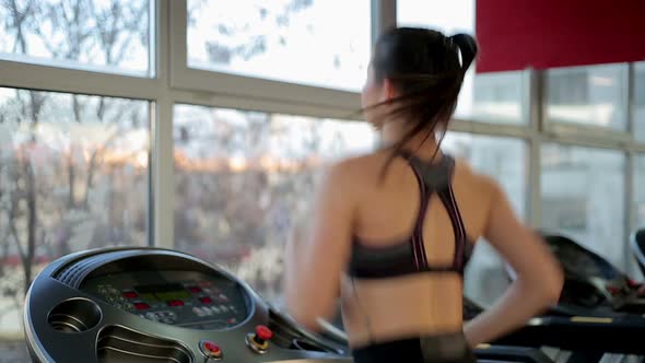 Active Young Woman Exercising on Treadmill, Training Hard to Have Fit Body