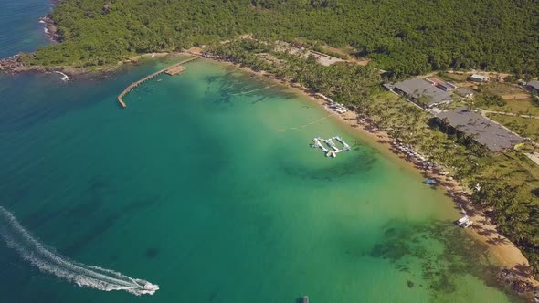 Aerial Flight Over a Boat Sailing Fast in a Tropical Lovely Island Resort