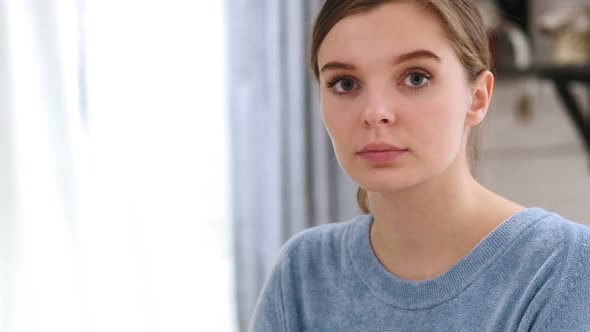 Close Up of Serious Beautiful Young Woman Model at Home