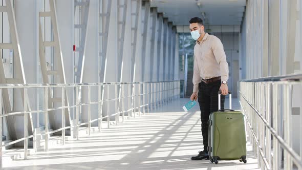 Successful Hispanic Business Man Passenger Investor Wears Face Medical Mask Shows Plane Ticket