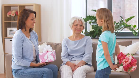 Granddaughter Giving Flowers To Grandmother 31