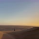 A Young Woman Walks Along Sandy Dunes in Namibia - VideoHive Item for Sale