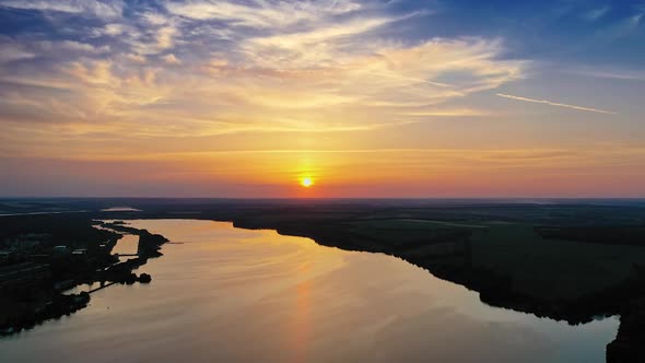 Beautiful river background among fields at dusk.