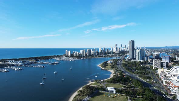 High revealing aerial view of a coastal urban metropolitan sprawl with a towering high-rise skyline