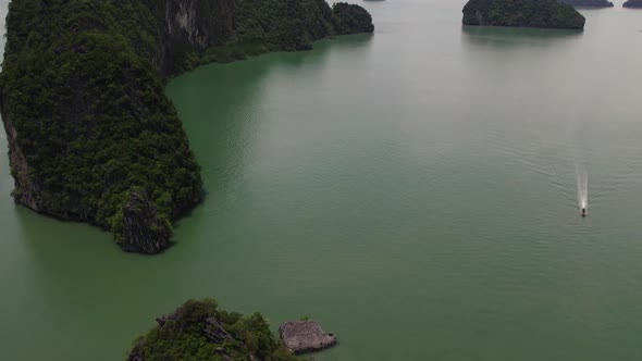 Drone tilt up, Phang Nga bay, boat spotted. Thailand