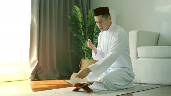 Asian Muslim Man Praying at Home