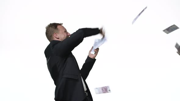 Business Man Throws Money in the Studio on a White Background