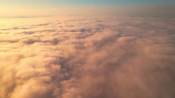 4K Aerial video Beautiful sunrise above dense clouds and fog in the morning