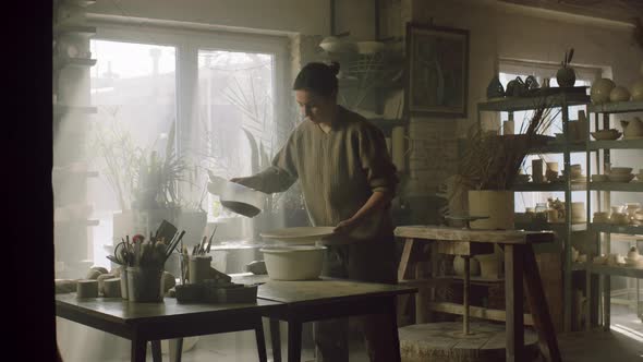 Woman Is Glazing Ceramic Plate