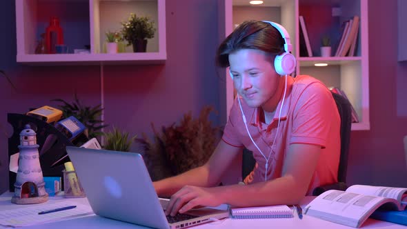 Young man rejoicing in his room.