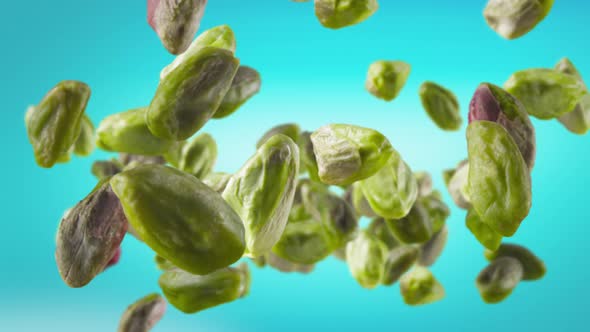 Flying of Peeled Pistachios in Ice Blue Background