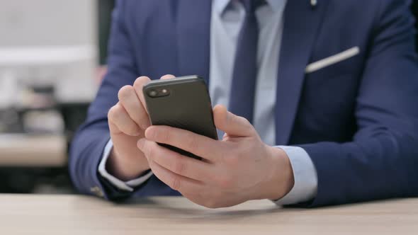 Hand Close Up of Businessman Using Smartphone