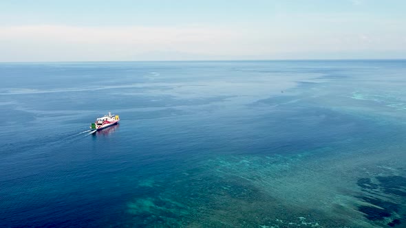 Passenger ferry making it's way through the coral reef on the coral triangle of Timor Leste, South E