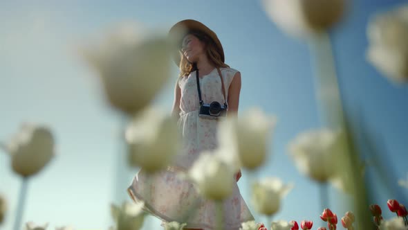 Unknown Elegant Lady with Photocamera Enjoying Summer Day in Park with Flowers