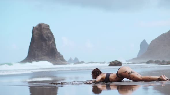 Woman in Swimsuit Dancing While on the Beach with Black Sand Near the Ocean Canary Islands