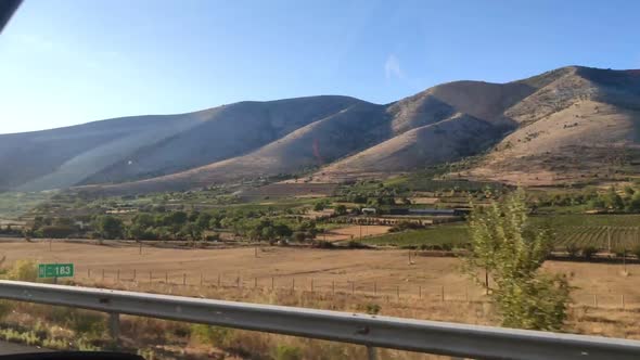 Car Travel Concept View of North Macedonia Mountains in Side Window