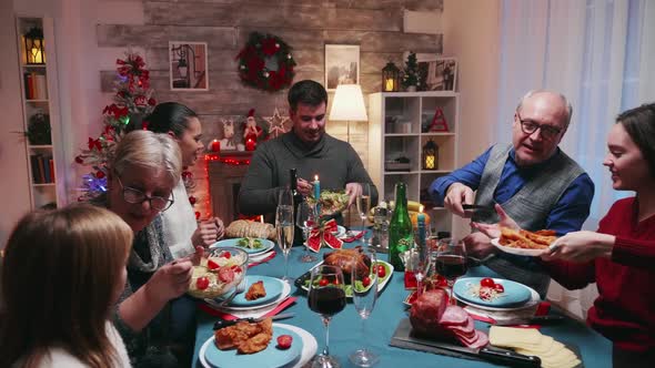 Big Family Celebrating Christmas with Delicious Food