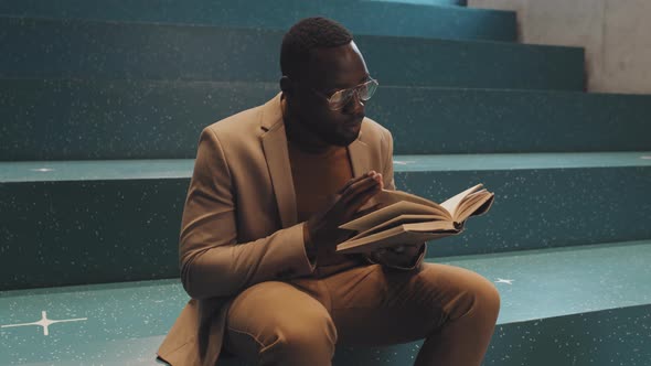 African-American Male University Student Reading Book