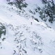 Side Aerial Over Winter Snowy Mountain with Mountaineering Skier People Walking Up Climbing - VideoHive Item for Sale