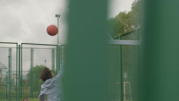 Man Scoring Points on Outdoor Basketball Court