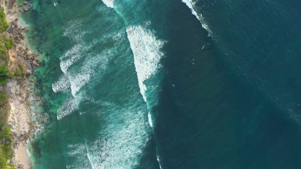 Aerial Top Down View of Giant Ocean Waves Crashing and Foaming