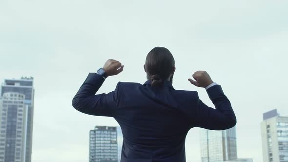 Cheerful Male in Business Suit Raising Hands Celebrating Success, Winner Gesture