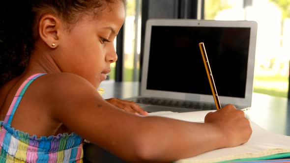 Schoolgirl doing homework in library 4k