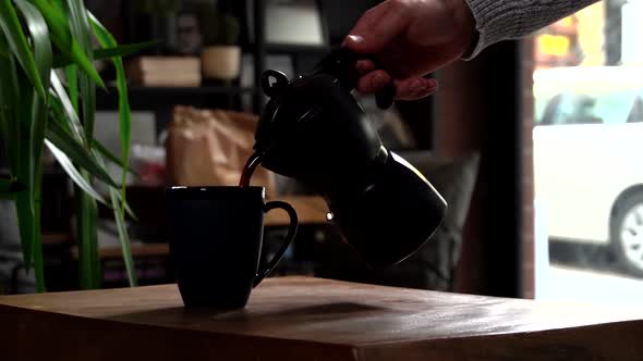 Cinematic Slow Motion Pouring Coffee in Navy Blue Mug from Black Mokapot