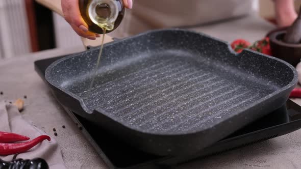 Woman Pouring Cooking Olive Oil on the Frying Pan